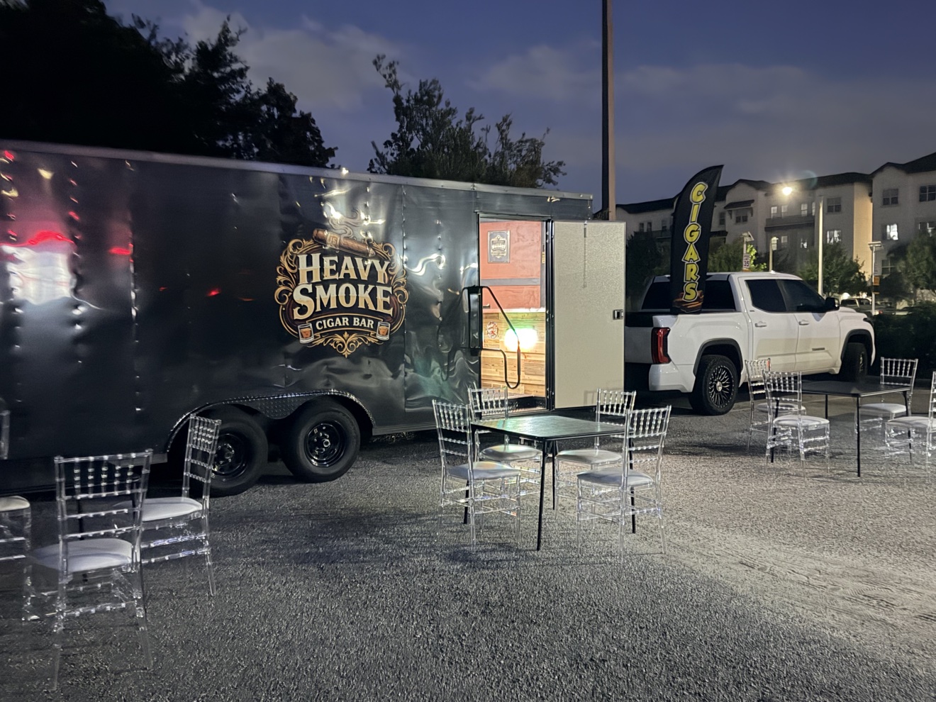 The Heavy Smoke mobile cigar bar trailer set up outside at night